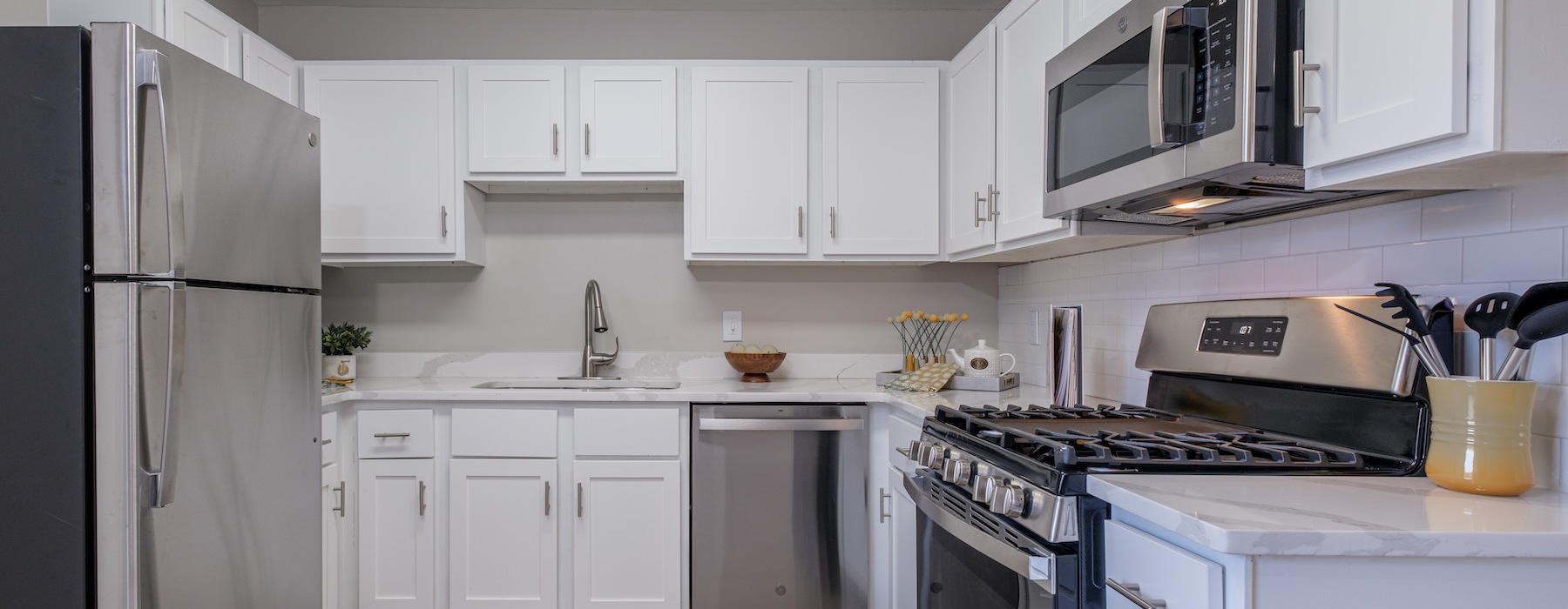 a kitchen with white cabinets