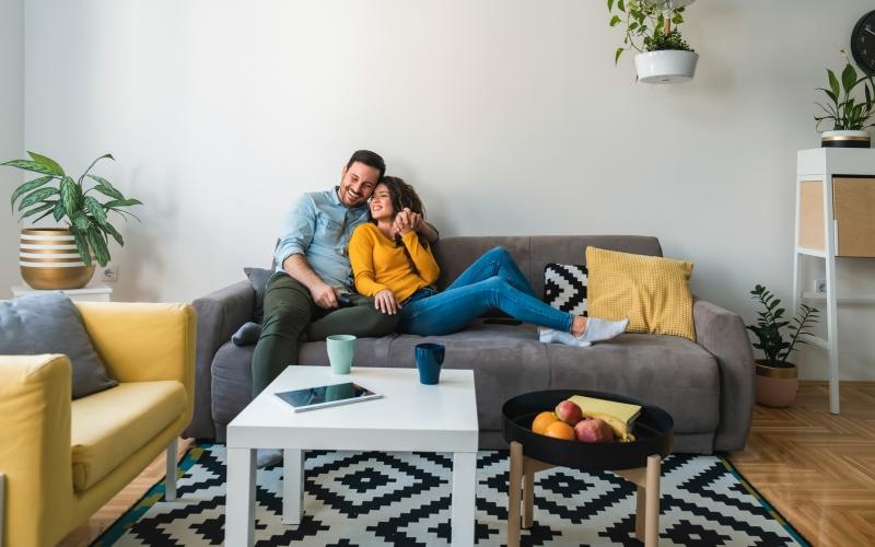 a man and woman sitting on a couch