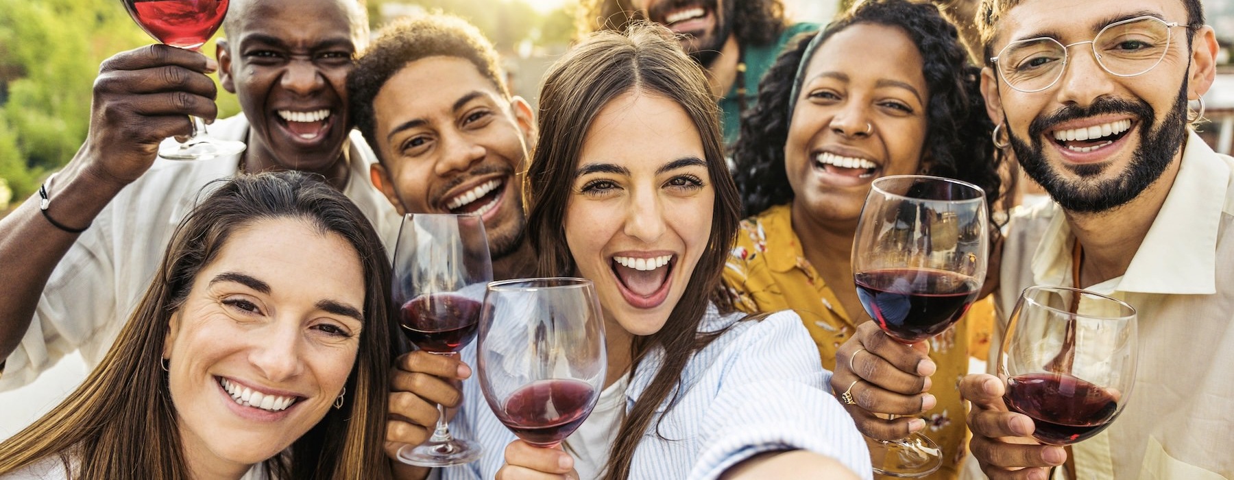 a group of people holding wine glasses