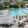 a swimming pool with chairs and tables